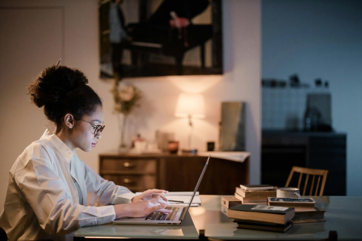 Woman using laptop to study at home.